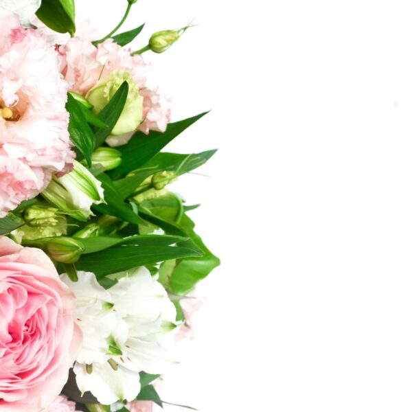 A stunning bouquet of pink roses and white lilies with lush green leaves.